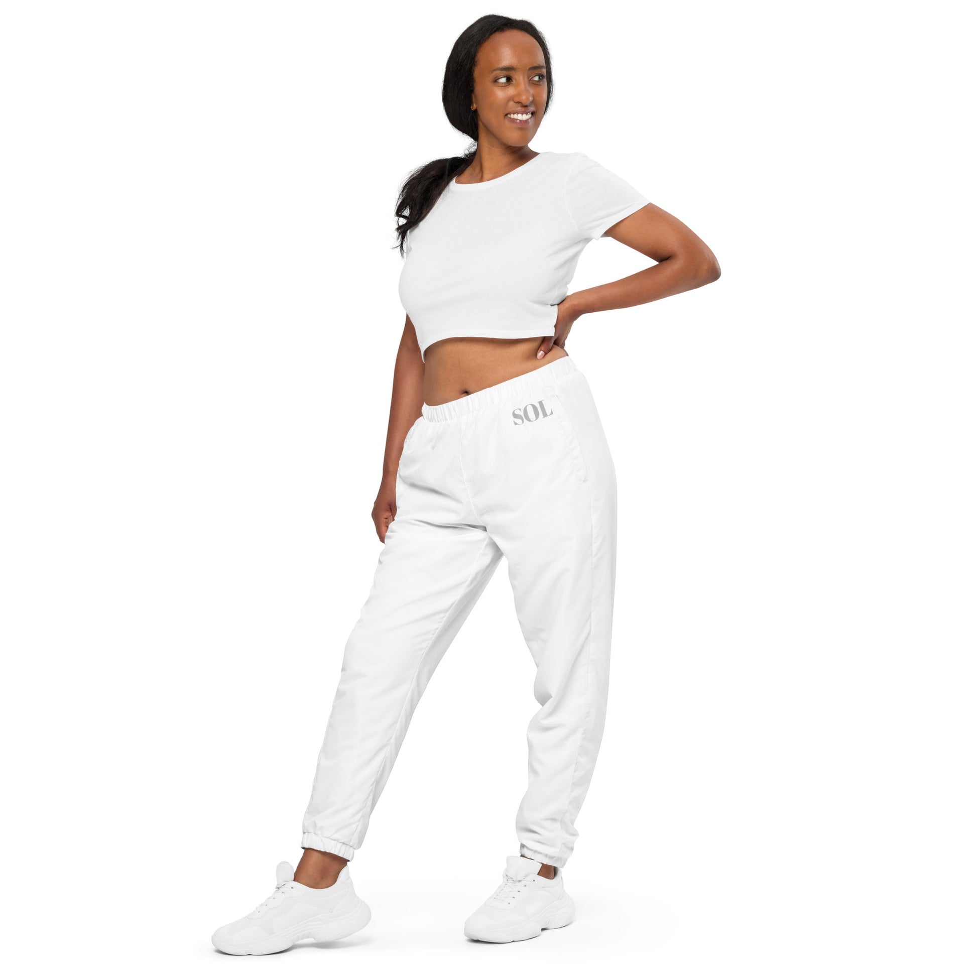 SOL Unisex Track Pants in White — angled front view
