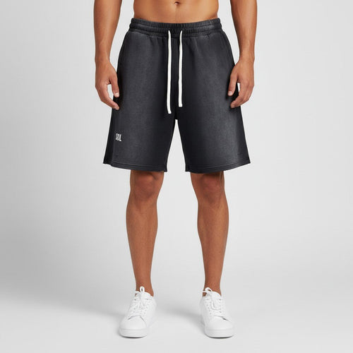 Model wearing black SOL Badlands Distressed Shorts with SOL print and white drawstrings