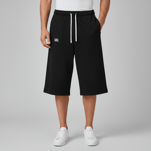 Model wearing black SOL Coastline Cropped Sweatpants, with white drawstrings and small white thigh logo.