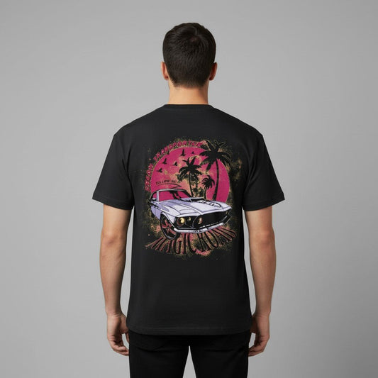 Adult model wearing the black SOL Coldfront Cooling Tee, showing the colorful tropical car and palm tree back print.