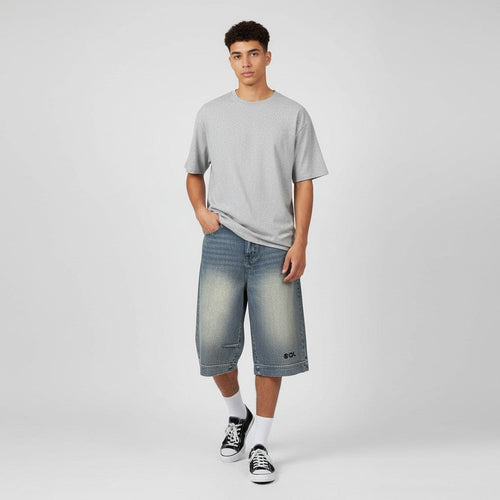 Model wearing washed blue SOL Drifter Denim Shorts with black SOL print near the hem