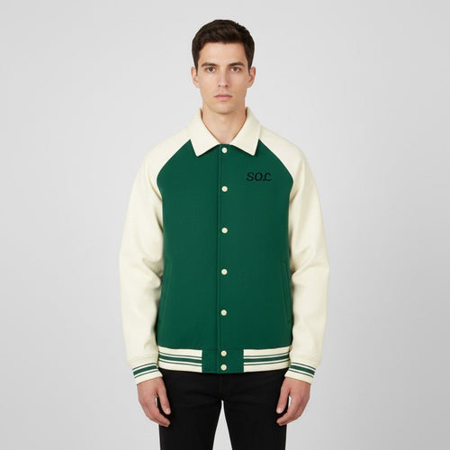 Model wearing the green and apricot SOL Dugout Varsity Jacket, front view with SOL chest print