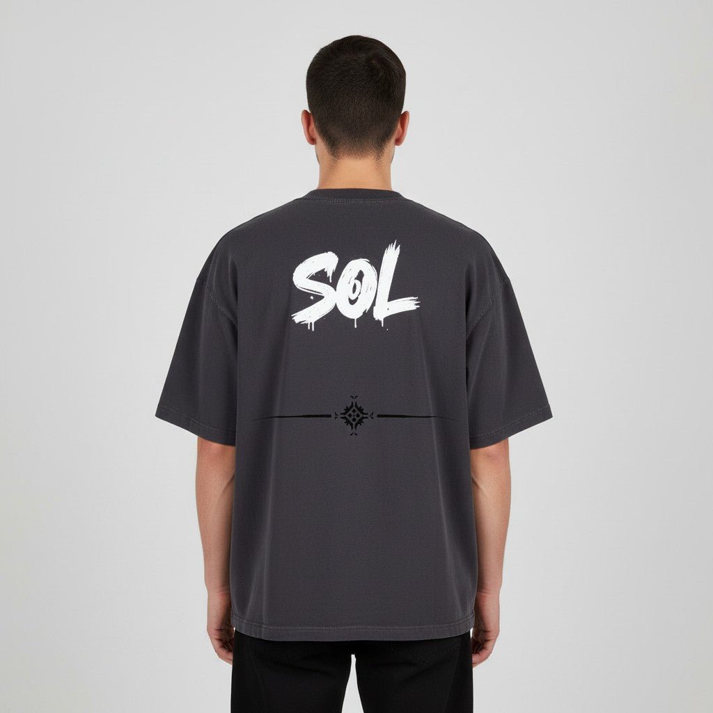 Model wearing black SOL Relic Boxy Tee, rear view showing white SOL artwork and decorative back graphic
