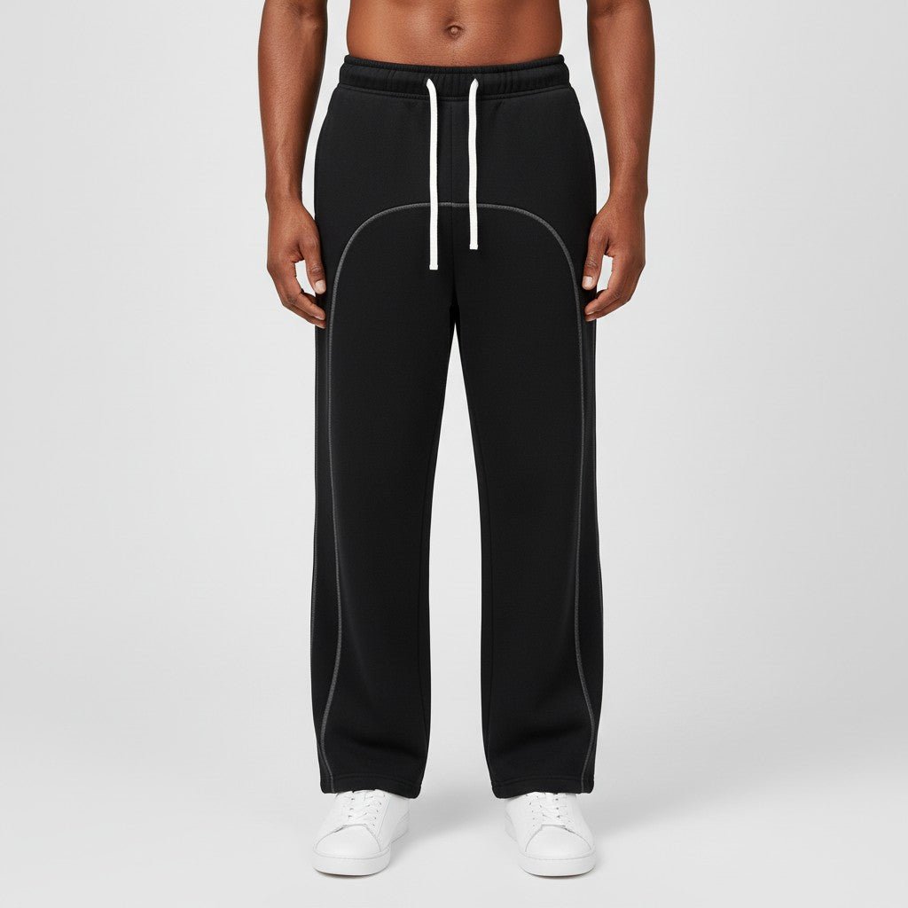 Model wearing black SOL Seamwork Fleece Sweatpants with white drawstrings and curved contrast seams