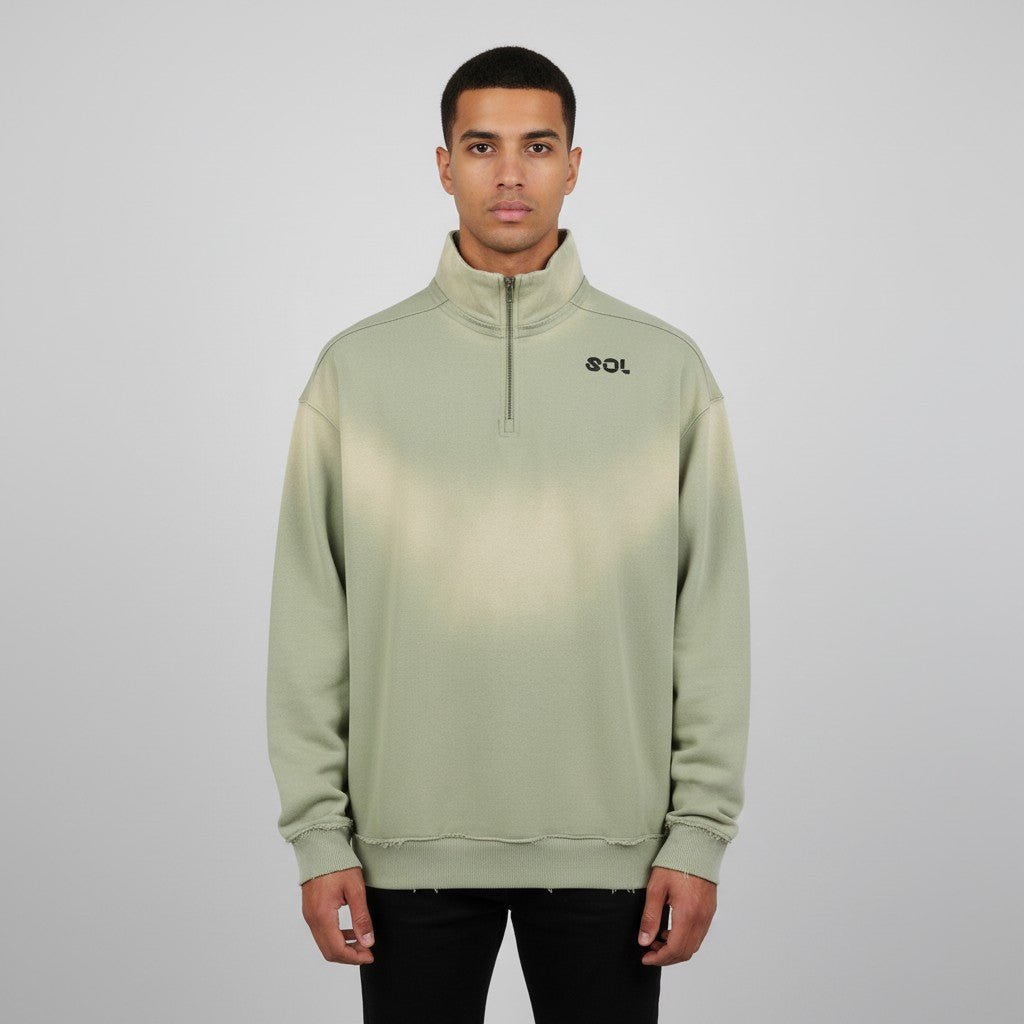 Model wearing gray green SOL Solstice Raw-Edge Quarter Zip with sun-faded wash and chest logo